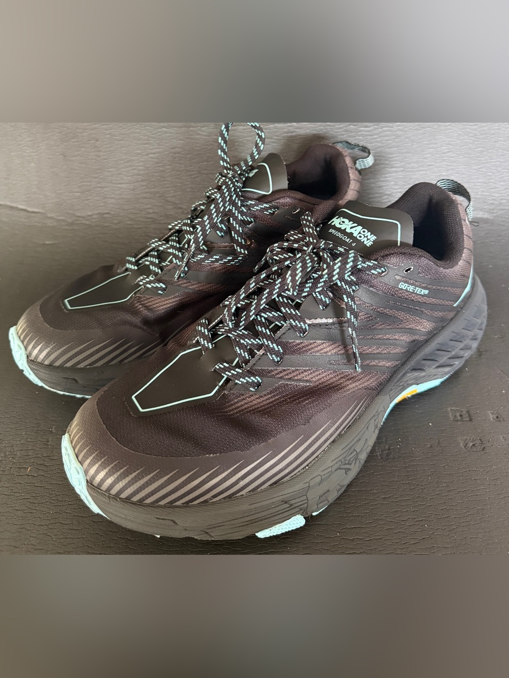 Hoka One One Men's Dark Brown Athletic Trail Shoes with Teal Accents
